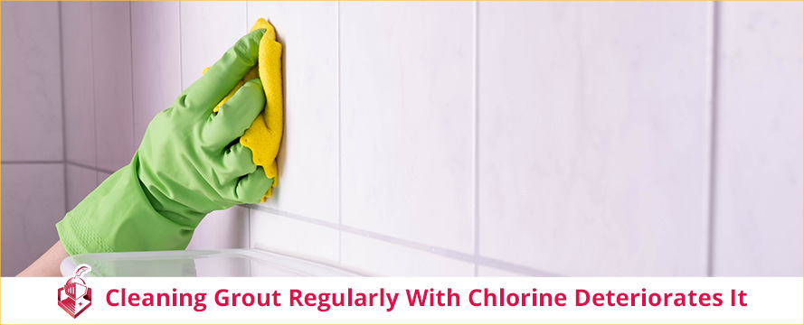 Hand Holding Towel Wiping Shower Tiles and Grout Using Chlorine Which Regular Use May Deteriorate Grout