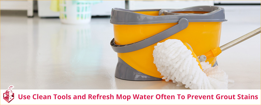 Bucket and Mop Inside Home as Using Clean Tools and Fresh Mop Water Prevents Grout Discoloration